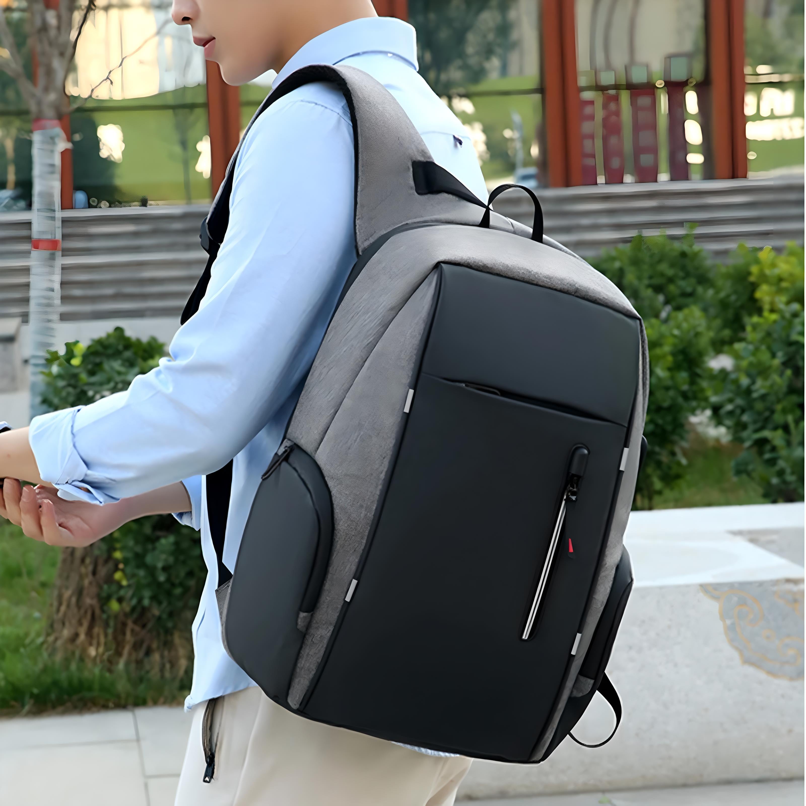 Man wearing a large, modern anti-theft backpack with USB charging port, walking outdoors. Stylish, secure travel bag for tech-savvy commuters.