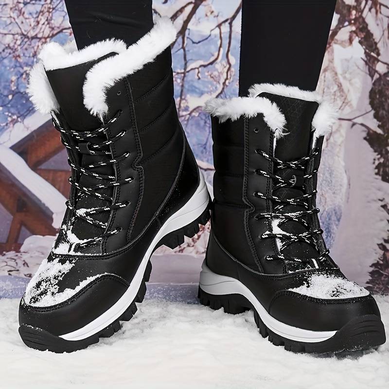 Black winter snow boots with white fur lining, durable soles, and lace-up design, perfect for cold weather. Snowy background enhances winter theme.