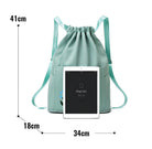 Mint green drawstring backpack with iPad Air mockup, featuring dimensions: 41cm height, 34cm width, 18cm depth. Ideal for tech-savvy travelers.