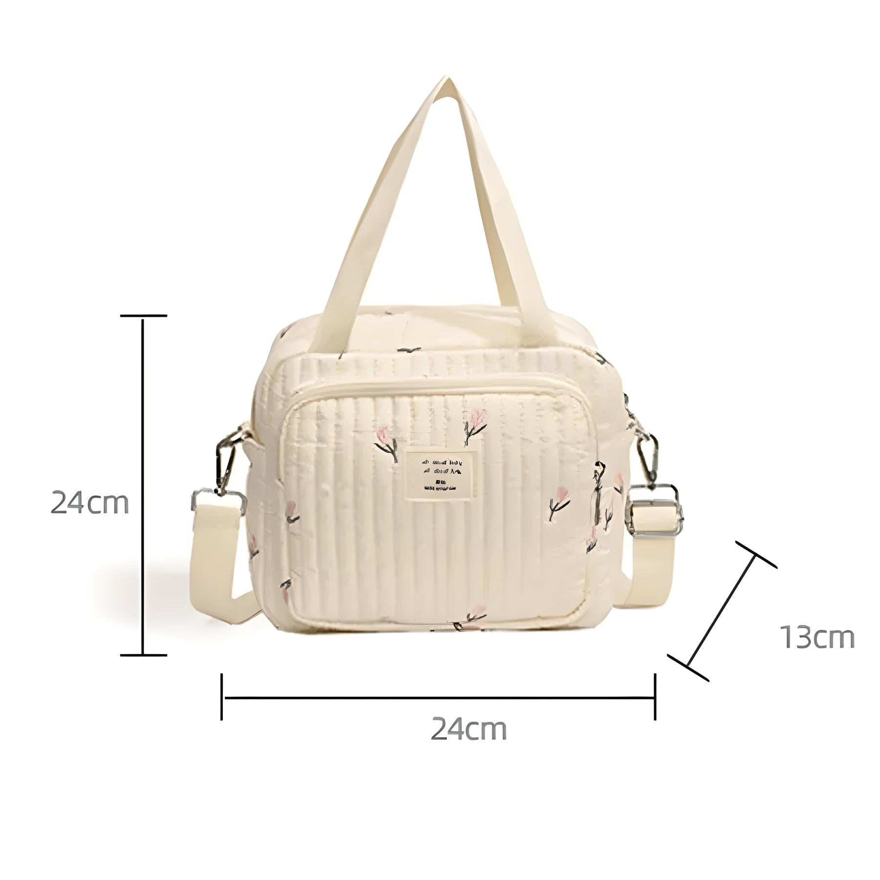 Cream quilted diaper bag with floral pattern, adjustable shoulder strap, and top handles. Dimensions: 24cm x 24cm x 13cm. Perfect for baby essentials.