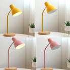 Modern desk lamps with wooden bases in yellow and pink colors, placed on a white table with small potted plants, ideal for home office decor.