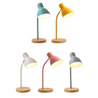 Colorful modern desk lamps with wooden bases and adjustable necks in teal, yellow, white, pink, and gray. Ideal for home office lighting decor.