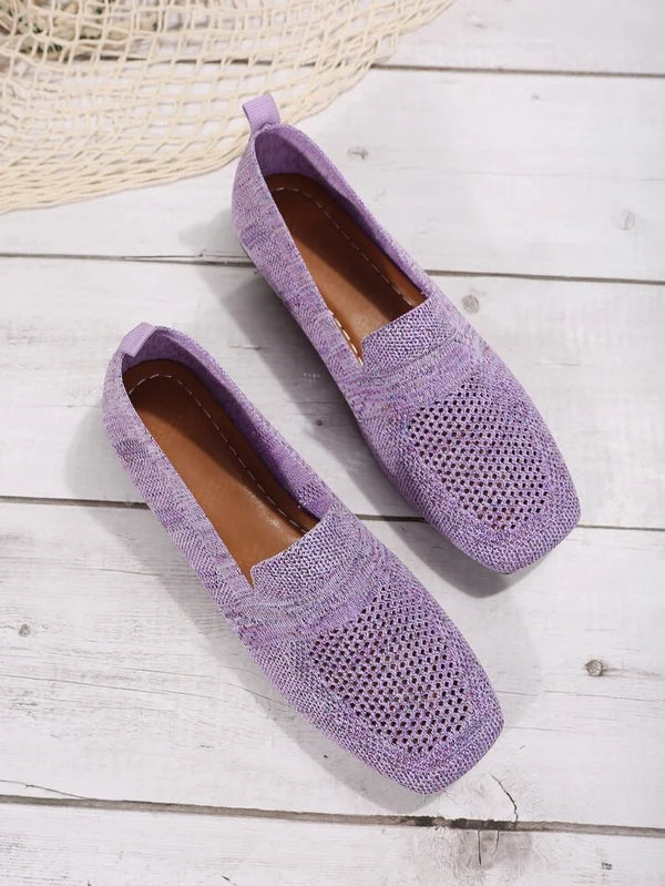 Purple woven loafers on wooden floor, featuring breathable design and slip-on style. Perfect for casual wear and summer fashion trends.