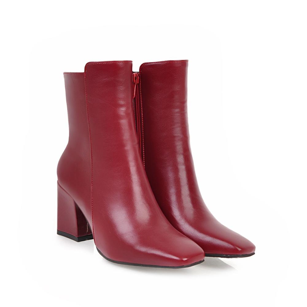 Red leather ankle boots with block heels, side zipper closure, and sleek design. Perfect for fashion-forward women seeking stylish footwear.