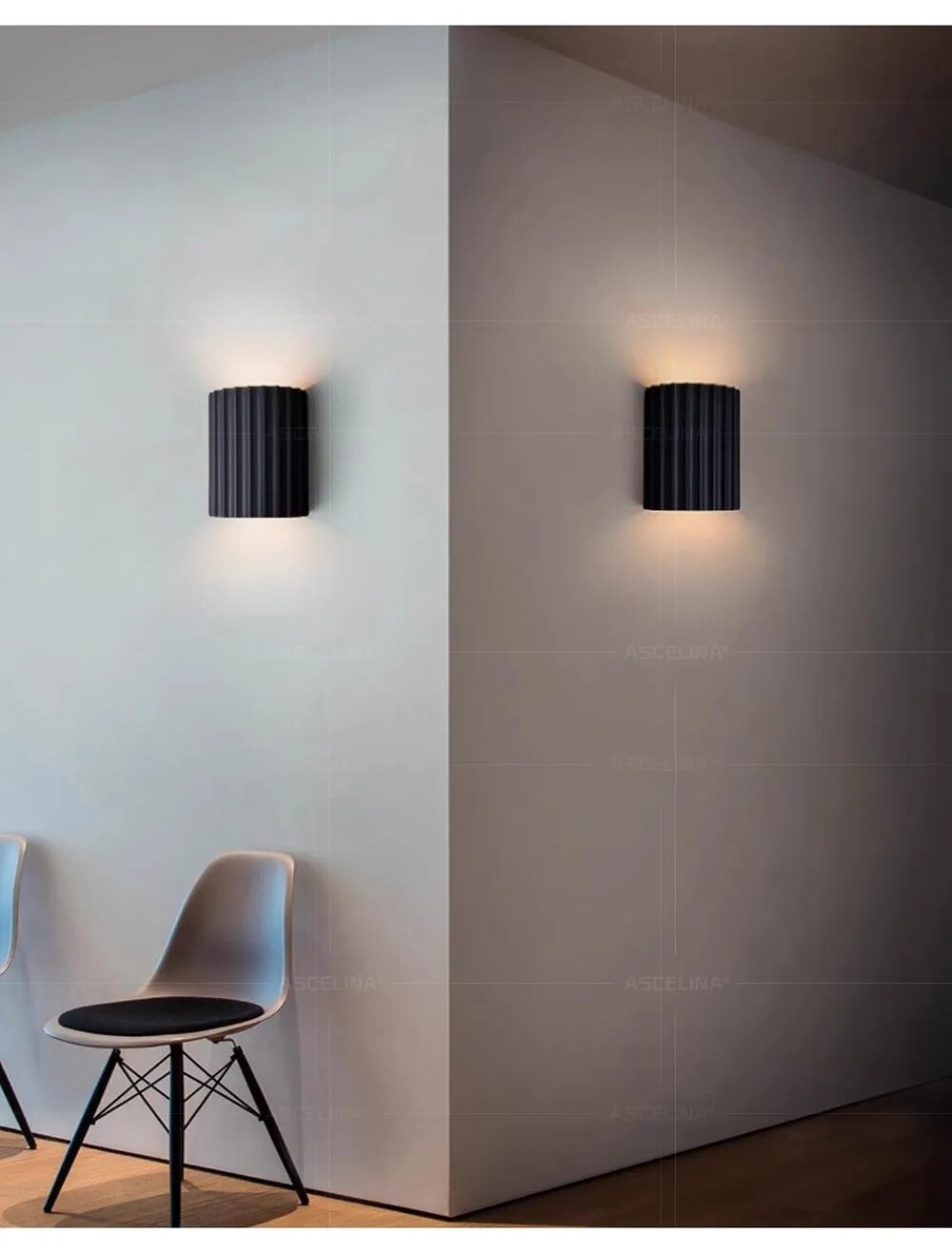 Modern black wall sconces illuminating a minimalist room corner with sleek chairs; contemporary interior lighting design, home decor inspiration.