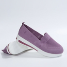 Purple slip-on sneakers with breathable mesh upper, white sole, and cushioned insole. Lightweight women's casual shoes for comfort and style.