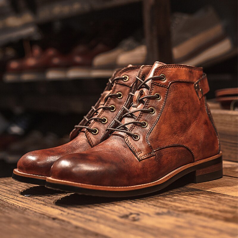 Brown leather men's boots with laces on a wooden surface, showcasing vintage style and craftsmanship. Perfect for casual and formal wear.