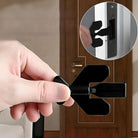 Hand holding a black door lock installation tool, demonstrating easy use on a wooden door. DIY home improvement, door security, lock installation.