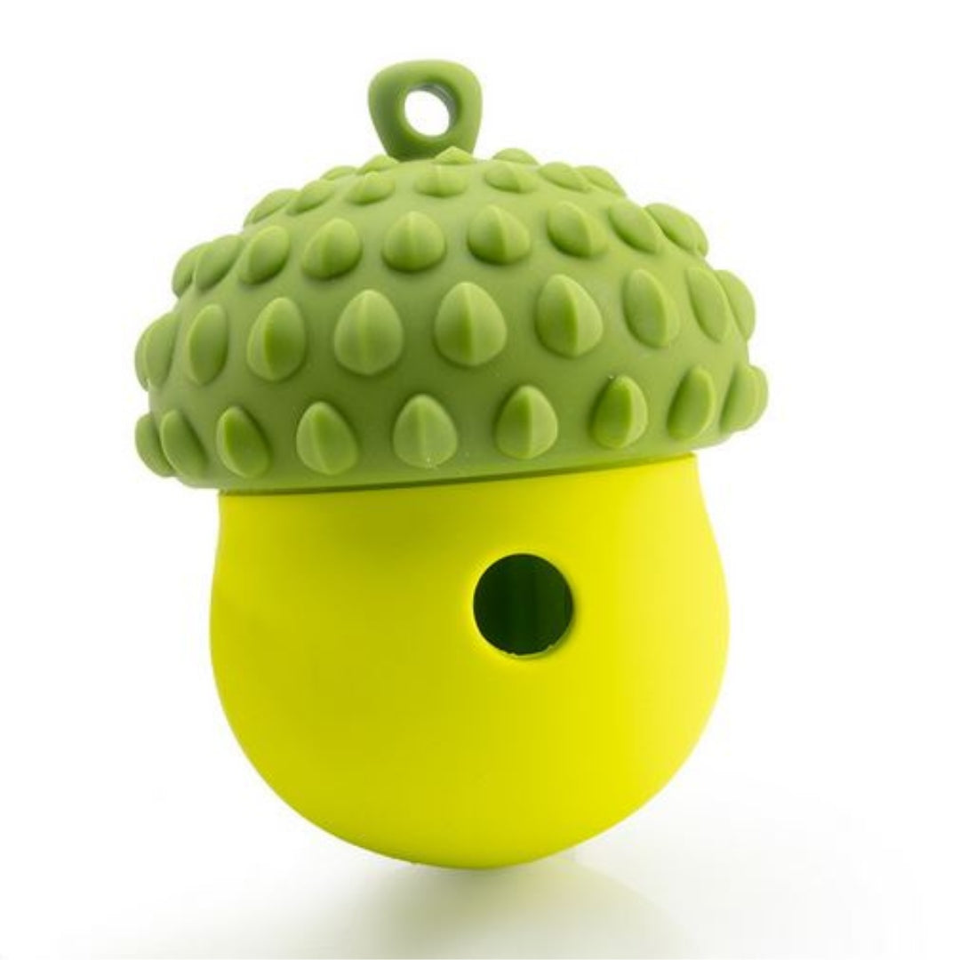 Green and yellow silicone acorn-shaped dog toy with textured surface and hole, ideal for pet chewing and interactive play. Durable pet accessory.