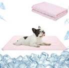 French Bulldog on pink cooling mat surrounded by ice cubes, with folded pink blanket above. Pet cooling mat, dog comfort, summer pet accessory.