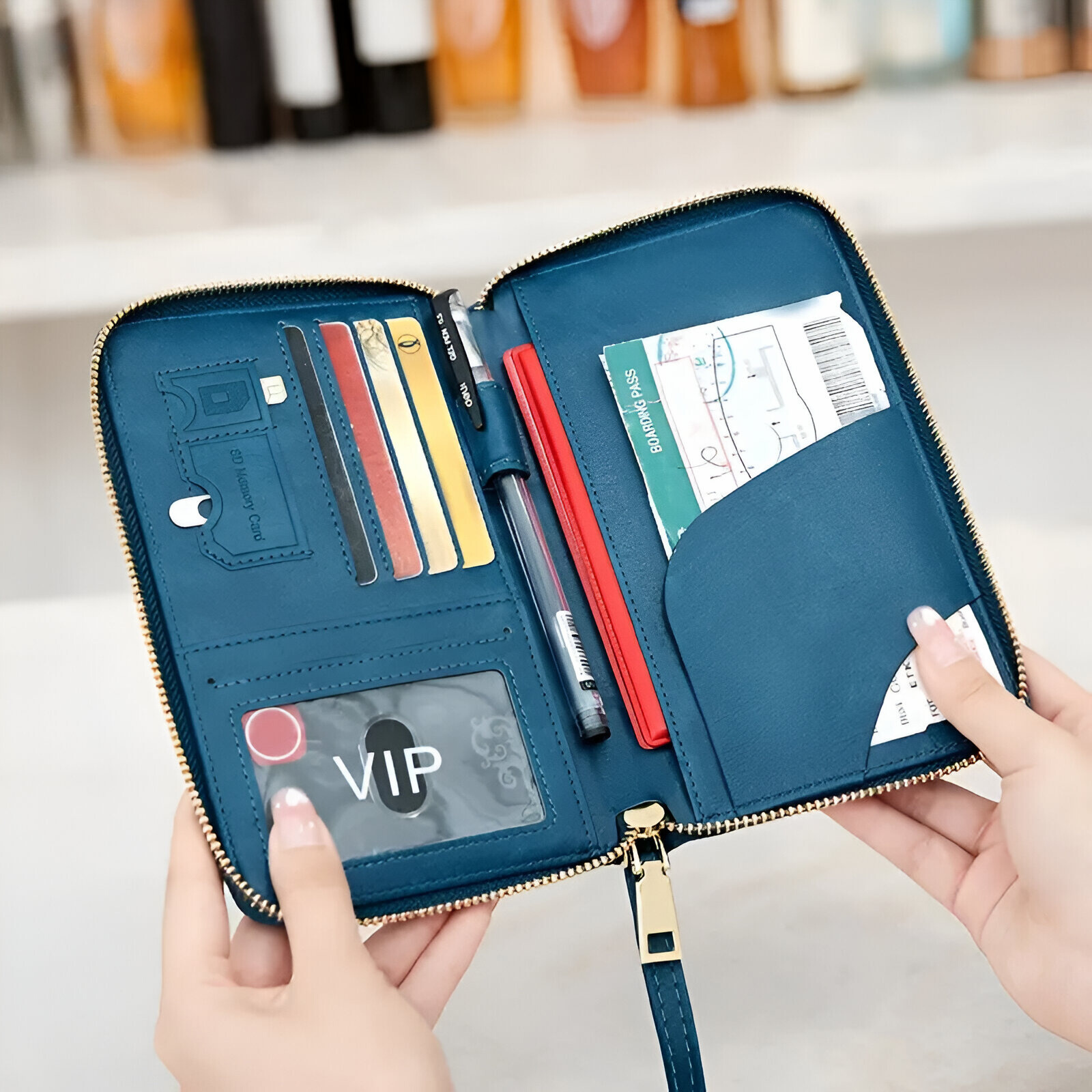 Blue leather travel wallet with zipper, featuring card slots, pen holder, and passport pocket. Ideal for organizing travel documents and essentials.