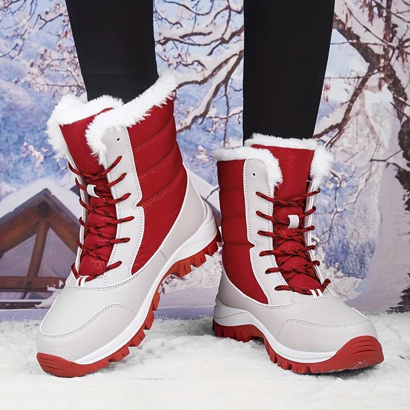 Red and white winter snow boots with fur lining, featuring durable soles and lace-up design, perfect for cold weather and outdoor activities.