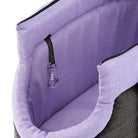 Pet carrier bag with purple interior, black exterior, and secure zipper closure. Features a safety clip for pet harness attachment. Ideal for small pets.