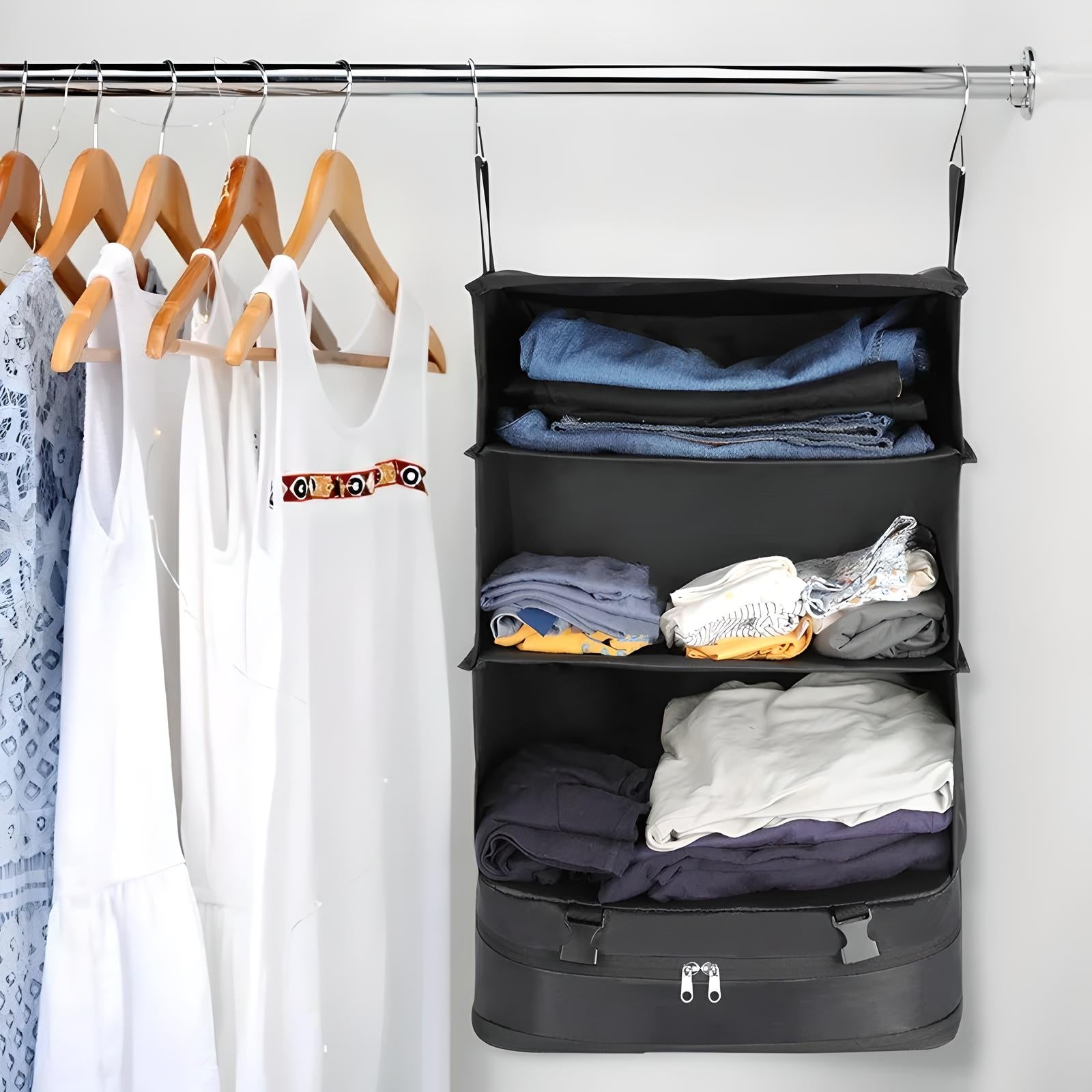 Hanging closet organizer with shelves storing folded clothes, next to wooden hangers with white and patterned dresses. Ideal for space-saving storage.