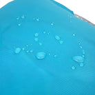 Water droplets on blue waterproof fabric, showcasing water-resistant material. Ideal for outdoor gear, rainwear, and protective clothing.