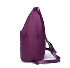 Purple backpack with side pockets and adjustable straps, featuring a sleek design. Ideal for travel, school, or work. Durable and stylish accessory.