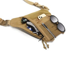 Tan crossbody sling bag with multiple compartments, showcasing sunglasses, smartphone, pen, and gadgets. Ideal for travel and everyday use.