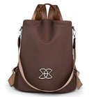 Stylish brown leather backpack with adjustable straps and silver logo, perfect for travel or daily use. Trendy women's fashion accessory.