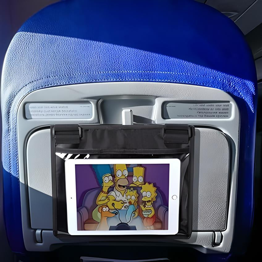 Airplane seat back with tablet holder displaying animated family show, blue seat cover, in-flight entertainment, travel convenience, passenger comfort.