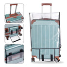 Clear protective suitcase cover on a teal hard-shell luggage with brown accents, featuring durable wheels and telescopic handle. Travel accessory.