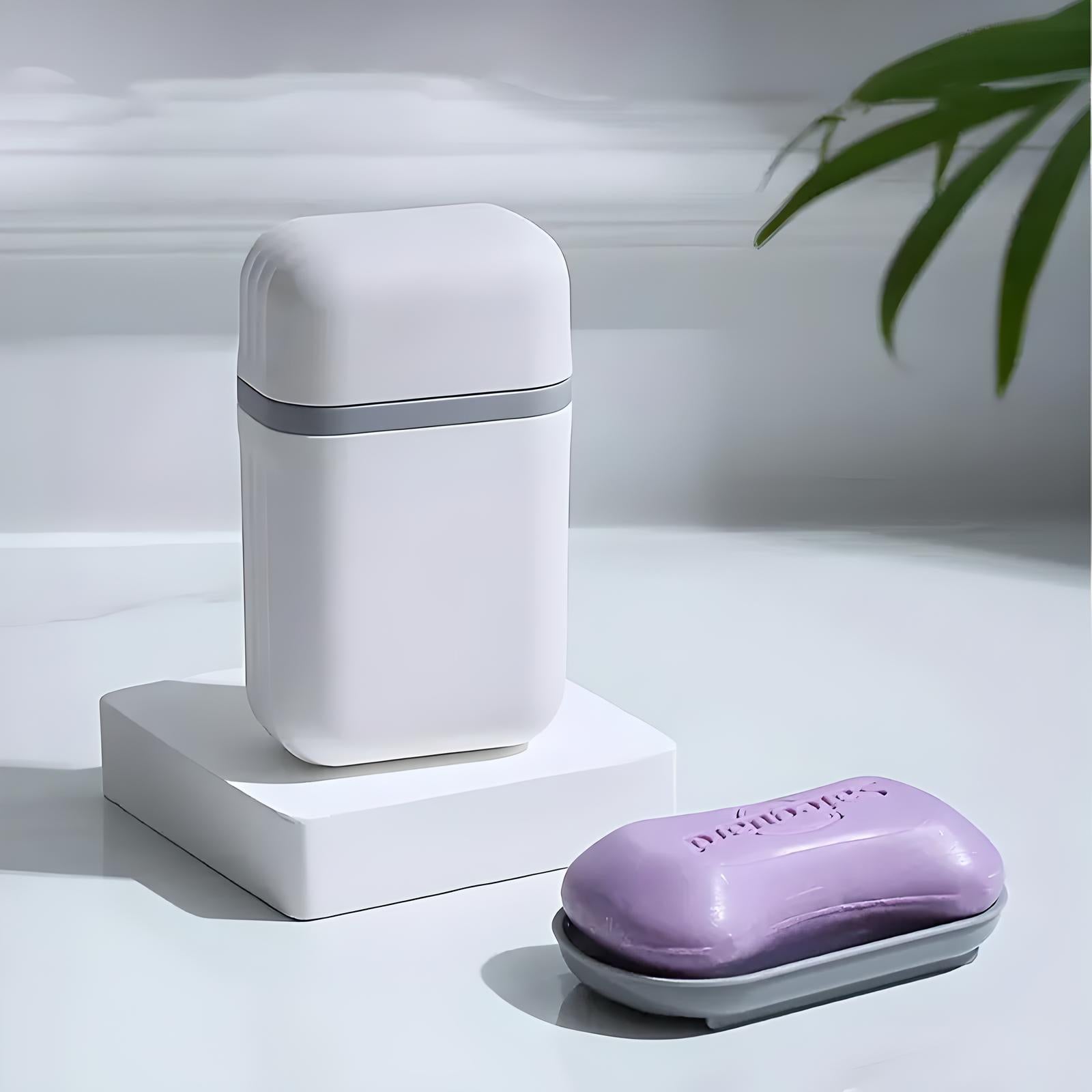 White deodorant container and purple soap bar on a minimalist bathroom counter with a plant. Personal care products, modern hygiene essentials.