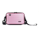 Pink hard shell crossbody bag with adjustable black strap, featuring a sleek ribbed design and logo accents. Stylish and durable travel accessory.