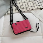 Pink crossbody bag with "Forever Young" strap, hard shell design, and wristlet. Stylish, trendy accessory for women. Perfect for casual outings.