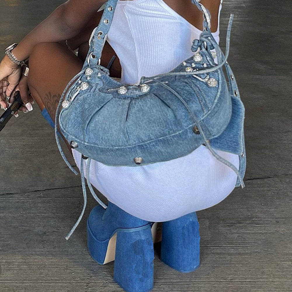 Trendy denim handbag with rhinestone embellishments, paired with matching blue platform heels. Fashionable accessories for a chic, modern look.