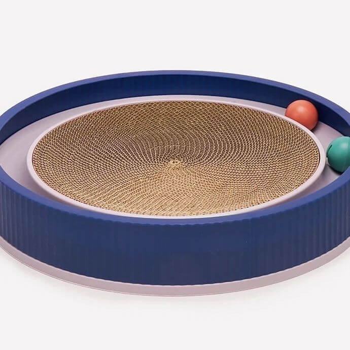 Cat scratcher toy with circular cardboard scratching pad, blue plastic rim, and two colorful balls. Ideal for interactive feline play and exercise.