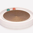 Round cat scratcher toy with cardboard center and two colorful balls, ideal for interactive play and claw maintenance. Perfect for active cats.