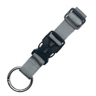 Gray nylon keychain with metal keyring and black plastic buckle, durable and adjustable. Ideal for keys, bags, and accessories.