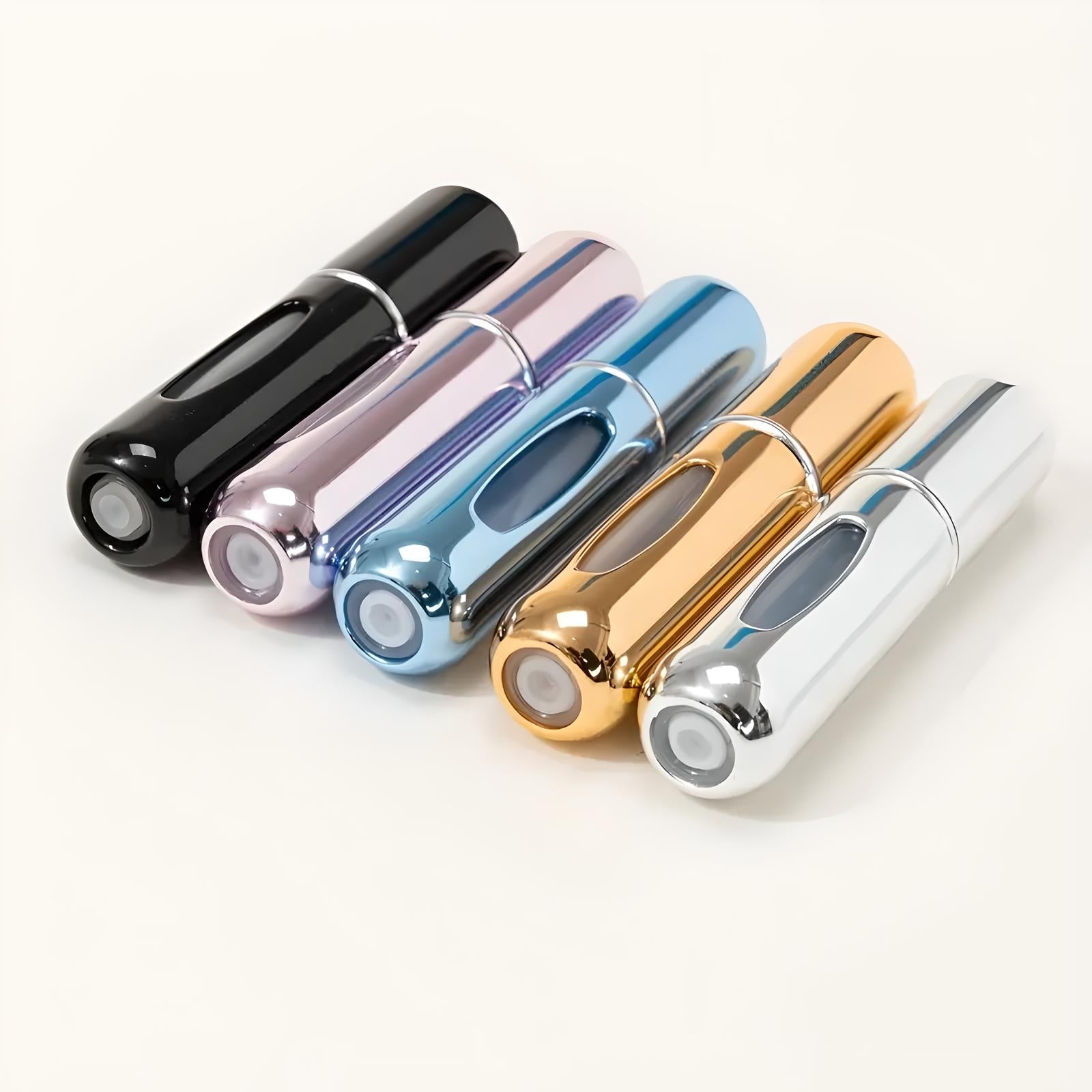 Five metallic travel perfume atomizers in black, pink, blue, gold, and silver, arranged in a row on a light background. Portable fragrance containers.