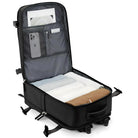 Open black travel suitcase with organized compartments, featuring folded clothes, a smartphone, and a laptop. Ideal for efficient packing and travel.