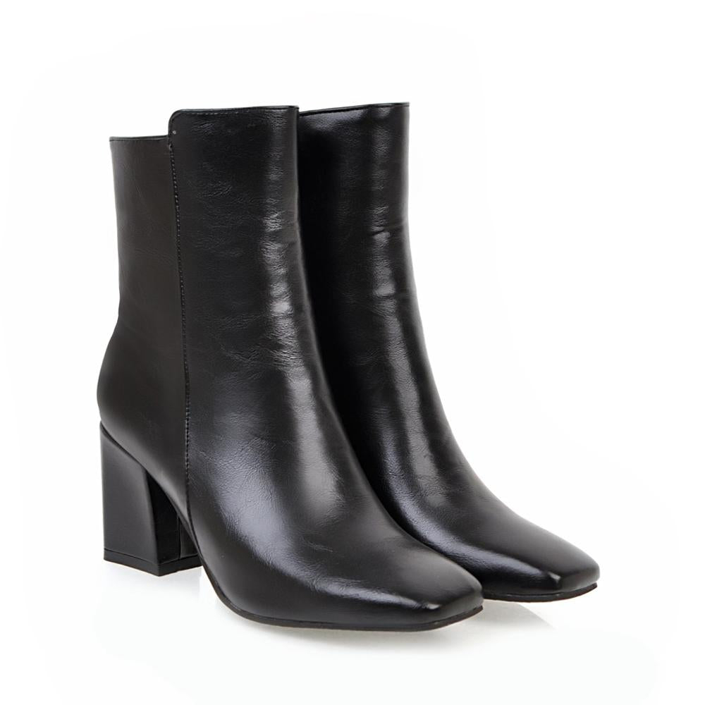 Black leather ankle boots with block heels, sleek design, and square toe. Perfect for fashion-forward style and comfort. Women's footwear.