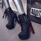 Black high-heeled ankle boots with red soles, featuring lace-up front and double buckle straps, paired with silver leggings. Fashionable women's footwear.