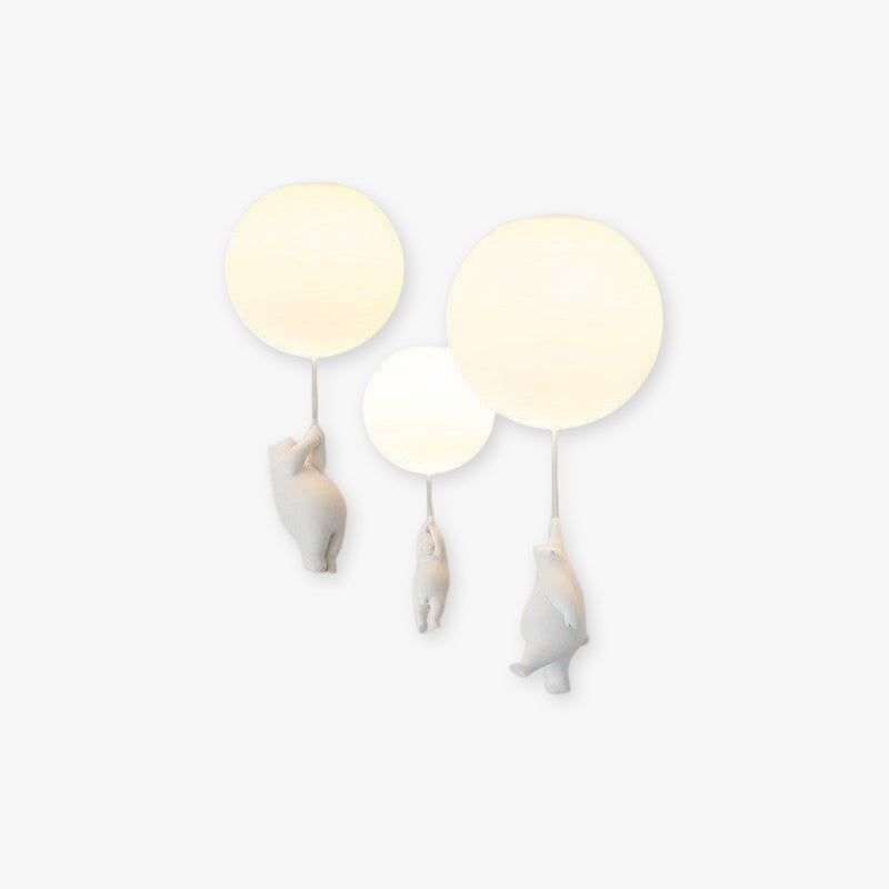 Modern wall lamp with three bear-shaped figures holding glowing round lights, minimalist design, perfect for children's room decor and ambient lighting.