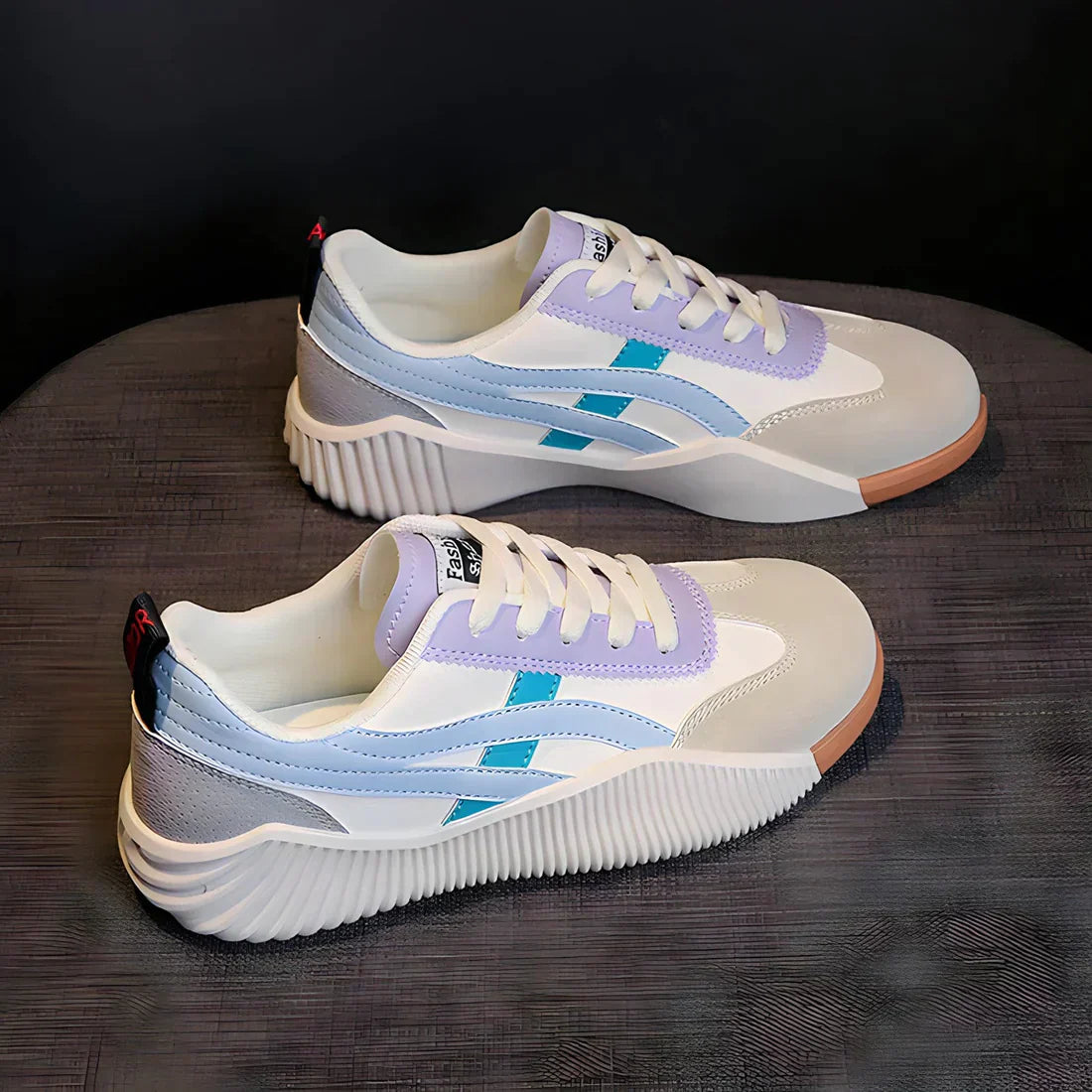 Stylish white and lavender sneakers with blue accents, featuring a modern design and textured sole, perfect for casual wear and fashion-forward looks.