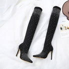 Black thigh-high stiletto boots with sparkling rhinestone embellishments on a white background, perfect for fashion-forward, glamorous outfits.