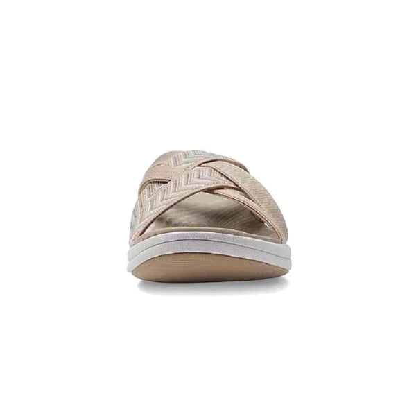 Front view of a beige women's sandal with crisscross straps and a cushioned sole, perfect for casual summer wear. Comfortable and stylish footwear.