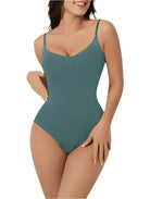 Woman wearing teal seamless bodysuit with adjustable straps, showcasing a sleek, form-fitting design. Perfect for fashion, lingerie, and shapewear keywords.