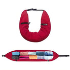 Red travel neck pillow with hidden storage compartments, showcasing organized packing of clothes. Ideal for travel convenience and space-saving.