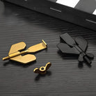 Gold and black toggle bolts on a sleek black surface, showcasing durable construction hardware. Ideal for secure wall mounting and heavy-duty applications.