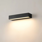 Modern black rectangular wall sconce with LED light, mounted on a neutral wall, ideal for contemporary home lighting and interior design.