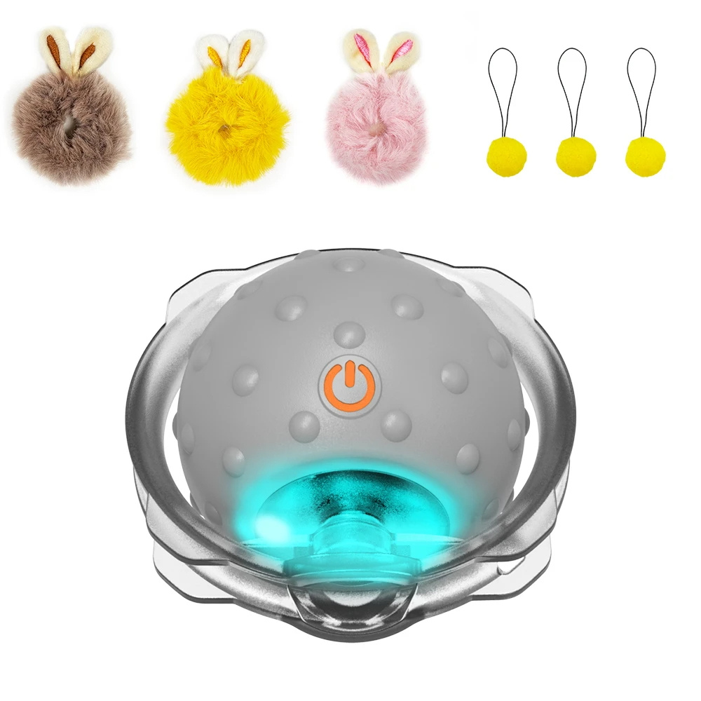 Interactive pet toy ball with LED lights, surrounded by colorful fluffy pom-poms and small yellow balls, ideal for cat play and exercise.