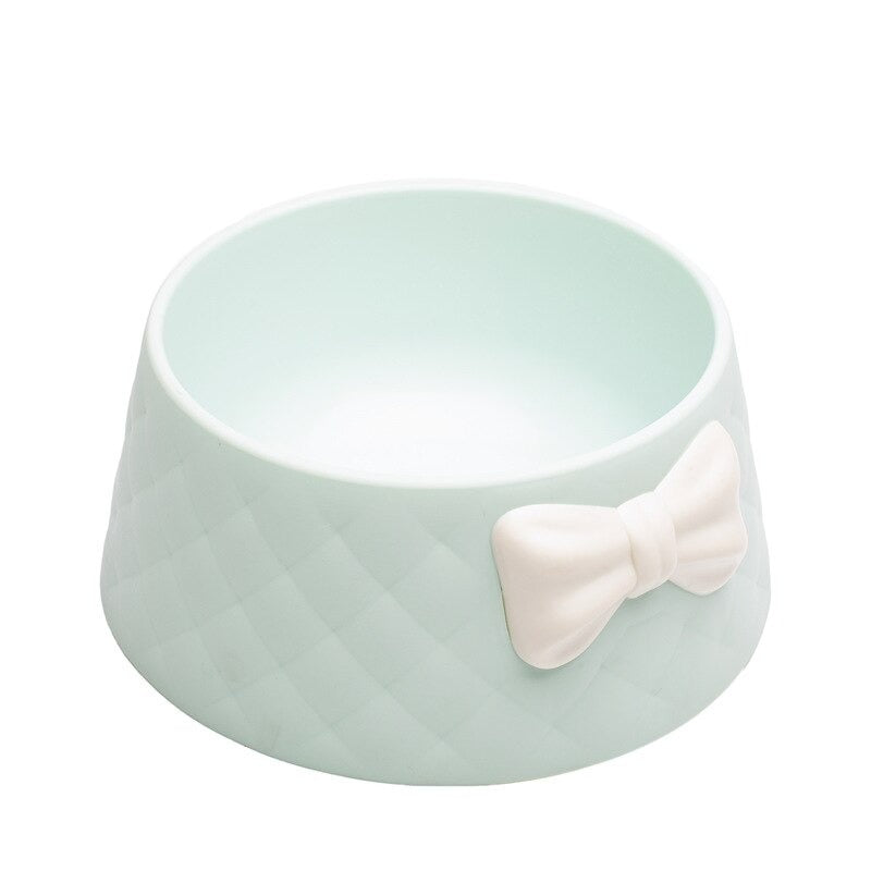 Mint green pet bowl with quilted texture and white bow, perfect for stylish dog or cat feeding. Durable, non-slip design for modern pet owners.