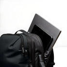 Black backpack with laptop and tablet in main compartment, showcasing tech-friendly design. Ideal for travel, work, and school. Durable and stylish.