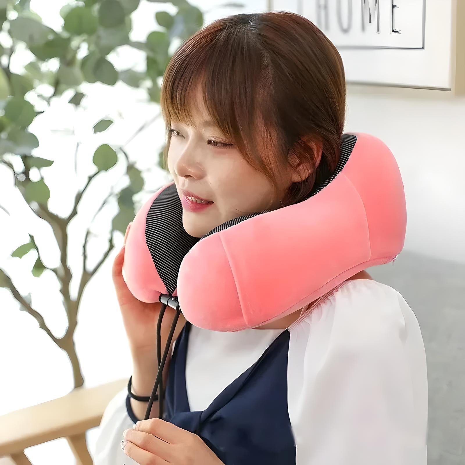 Woman using a pink memory foam travel neck pillow indoors, providing comfort and support. Ideal for travel, relaxation, ergonomic design.