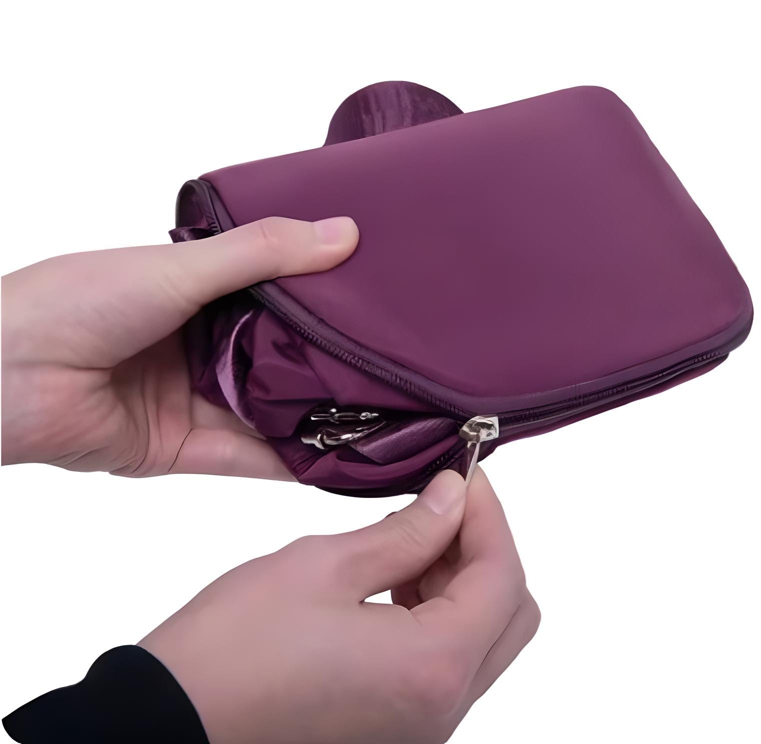 Hands holding a compact, foldable purple travel bag with a zipper, ideal for lightweight packing and convenient storage.