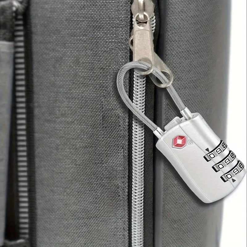 Gray suitcase with TSA-approved combination lock, secure travel luggage, durable zipper, anti-theft design, ideal for airport security checks.