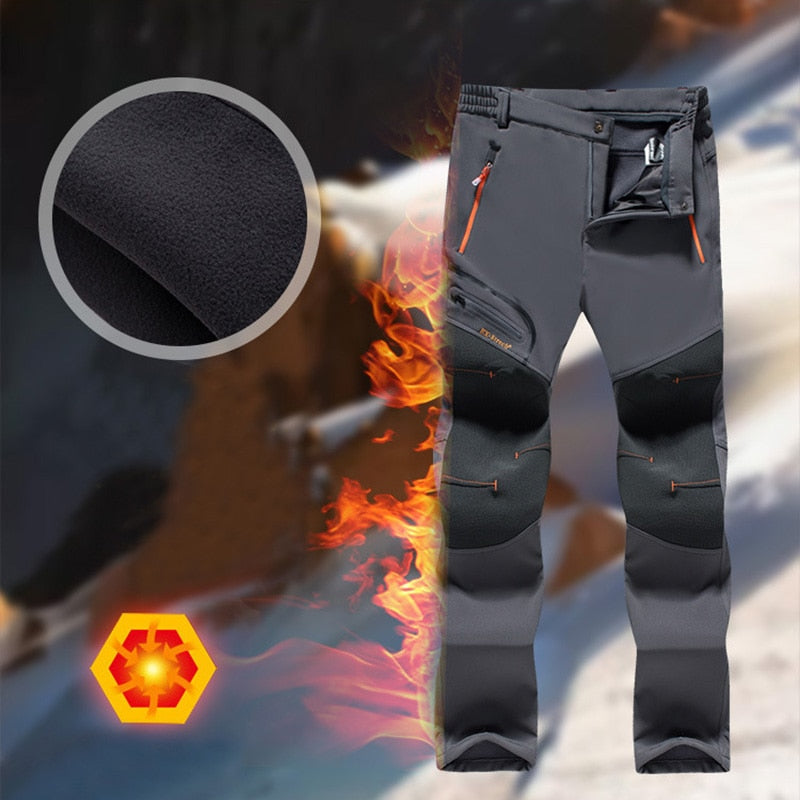 Men's thermal fleece hiking pants, waterproof, windproof, black with orange accents.